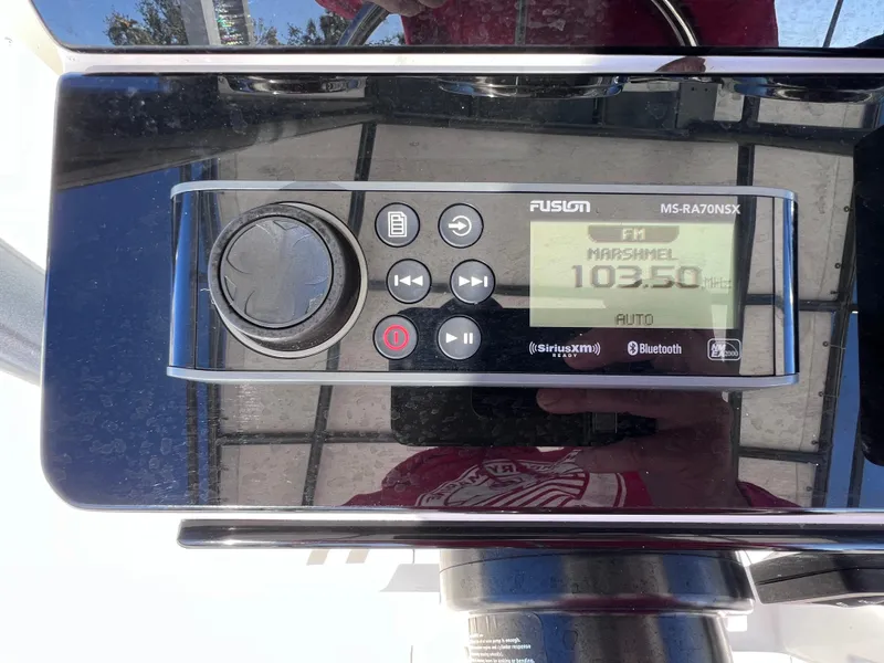 Slide: The Image of Fusion MS-RA70NSX marine stereo displaying FM 103.5, featuring Bluetooth and SiriusXM connectivity. - 11