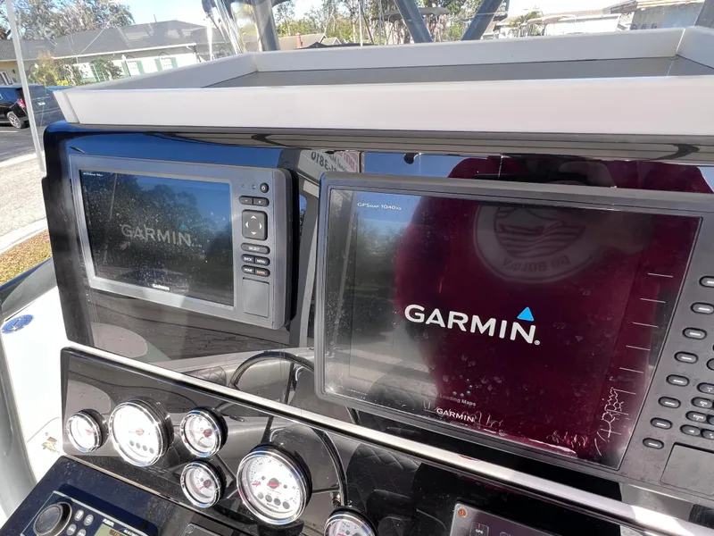 Slide: The Image of Garmin navigation displays on Dakota 32 cc 2023 Suzuki Motors boat dashboard, 1997 model. - 13