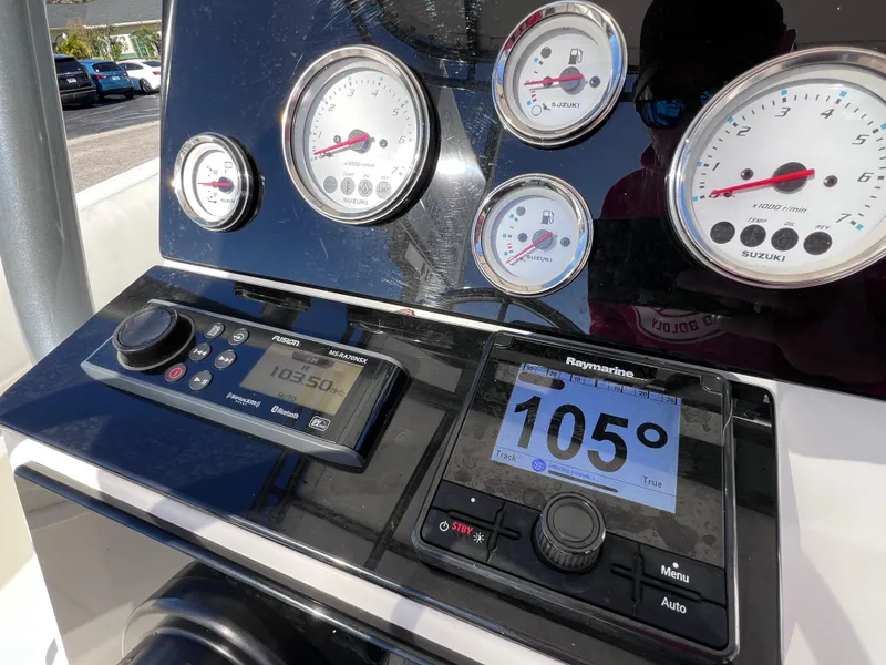 Slide: The Image of Dashboard of Dakota 32 cc 2023 Suzuki Motors boat with gauges and navigation display. - 15