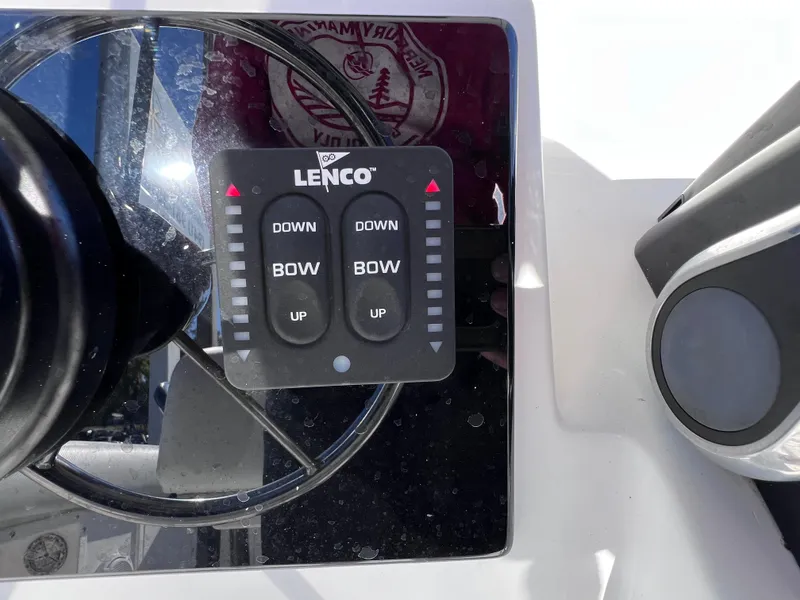 Slide: The Image of Control panel of a Dakota 32 cc 2023 Suzuki Motors boat, featuring Lenco trim tabs. - 16