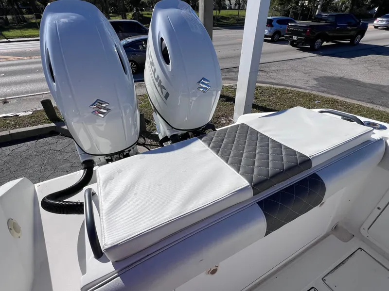 Slide: The Image of Dual Suzuki outboard motors on Dakota 32 cc boat, 2023 model, with cushioned seating. - 22