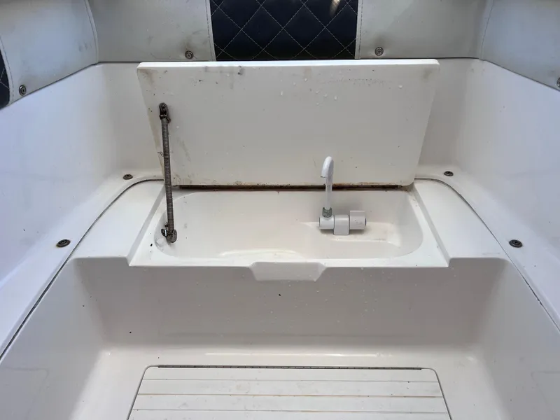 Slide: The Image of White boat interior with a built-in sink, Dakota 32 cc 2023 Suzuki Motors. - 6
