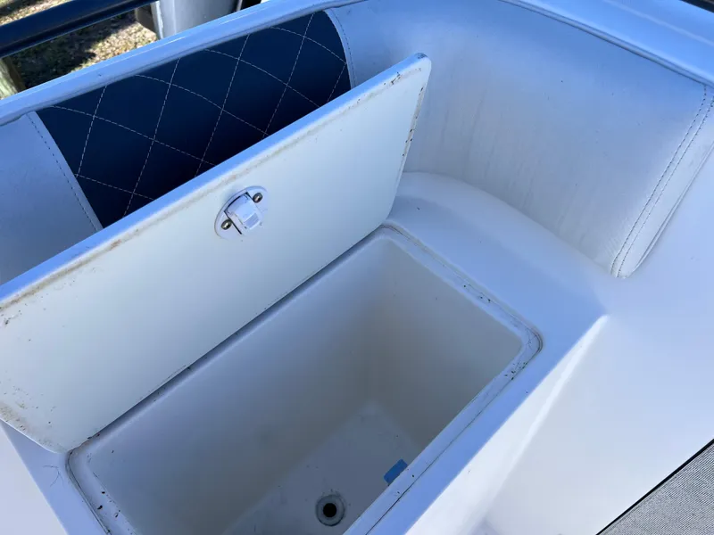 Slide: The Image of Open storage compartment on a 1997 Dakota 32 cc boat with Suzuki Motors. - 7
