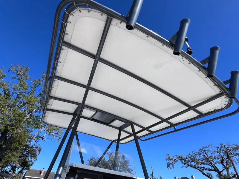 Slide: The Image of T-top of a 1997 Dakota 32 cc boat with Suzuki Motors, under a clear blue sky. - 8