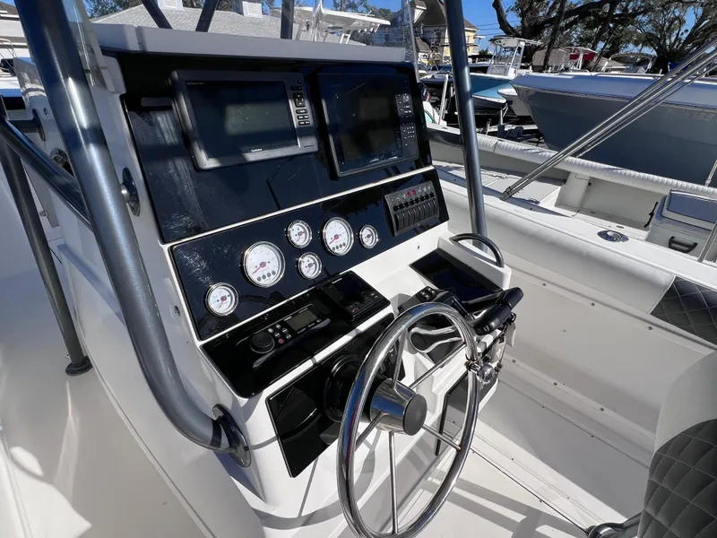 Slide: The Image of Control panel of a 1997 Dakota 32 cc boat by Suzuki Motors, featuring gauges and steering wheel. - 9