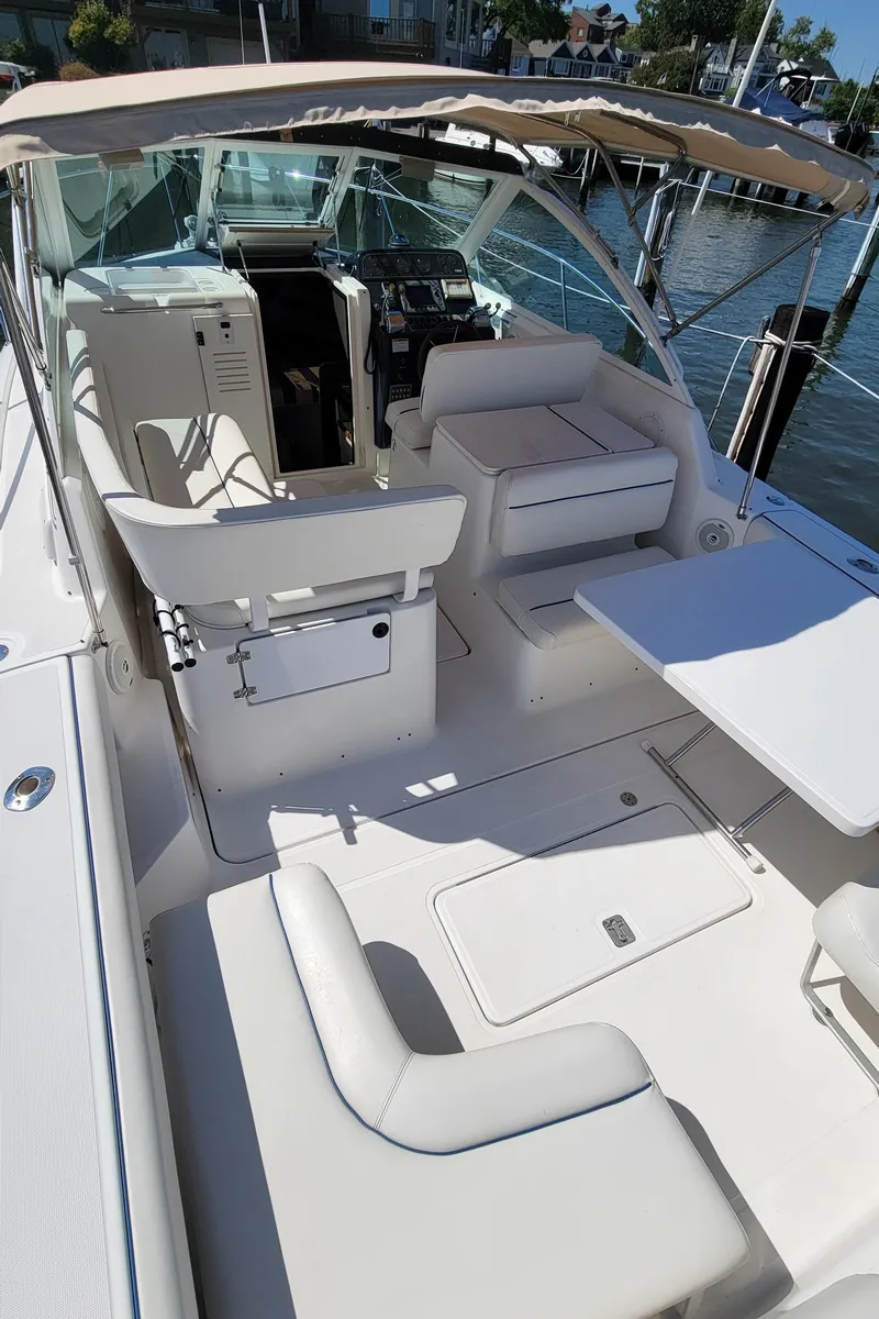 Slide: The Image of 2006 Tiara Yachts 2900 Coronet with spacious seating and helm, docked by the water. - 3