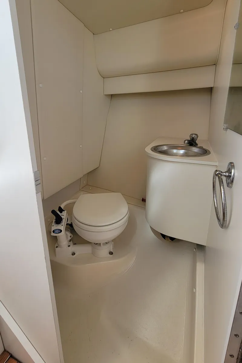 Slide: The Image of 2006 Tiara Yachts 2900 Coronet bathroom with compact toilet and sink. - 25