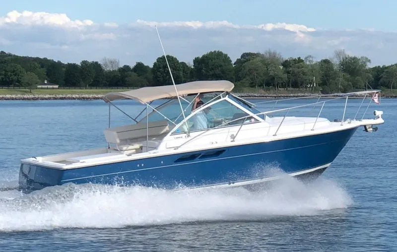The Image of 2006 Tiara Yachts 2900 Coronet cruising on a calm lake under clear skies. - 0