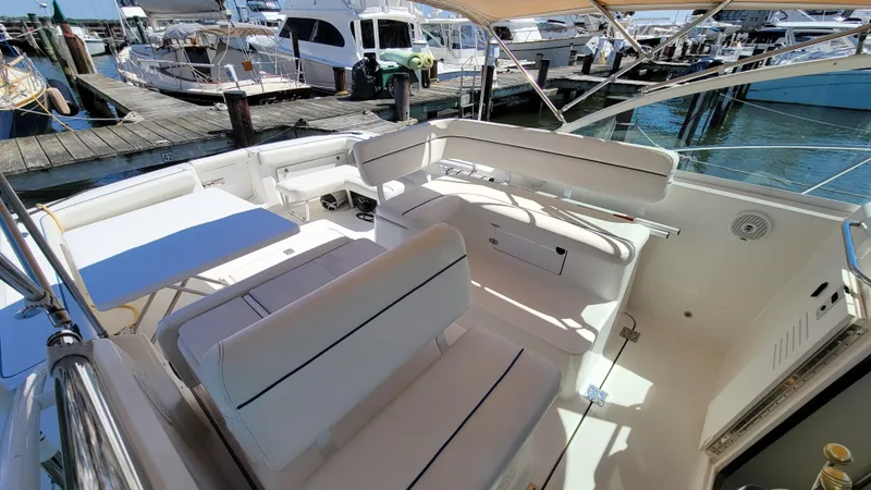 Slide: The Image of 2006 Tiara Yachts 2900 Coronet interior with seating and table, docked at marina. - 16