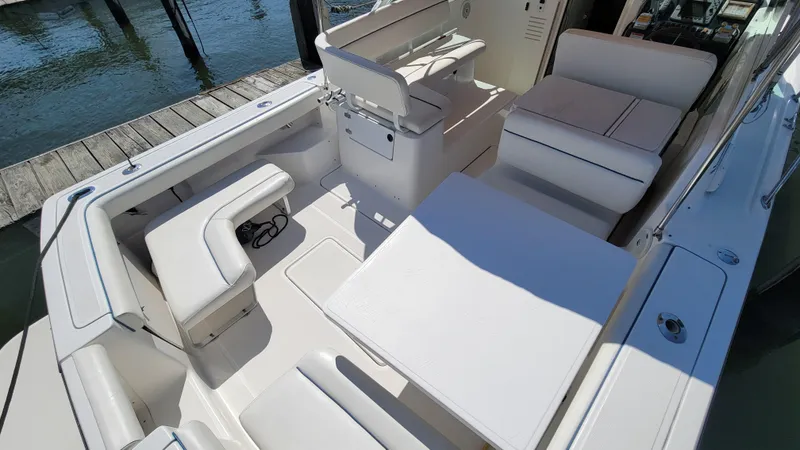 Slide: The Image of 2006 Tiara Yachts 2900 Coronet interior with white seating and table, dockside view. - 17