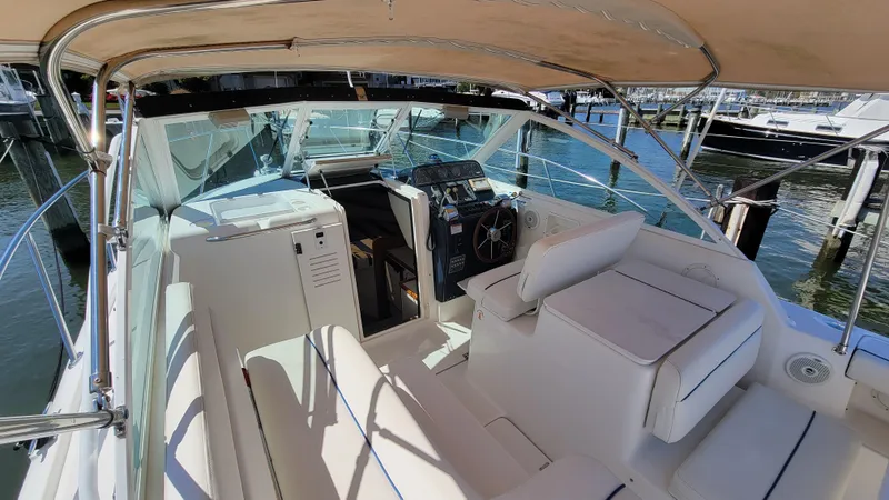 Slide: The Image of 2006 Tiara Yachts 2900 Coronet interior with helm, seating, and marina view. - 13