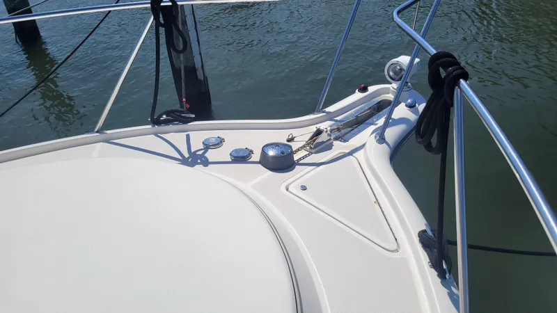 Slide: The Image of 2006 Tiara Yachts 2900 Coronet bow with railing and cleats on calm water. - 8