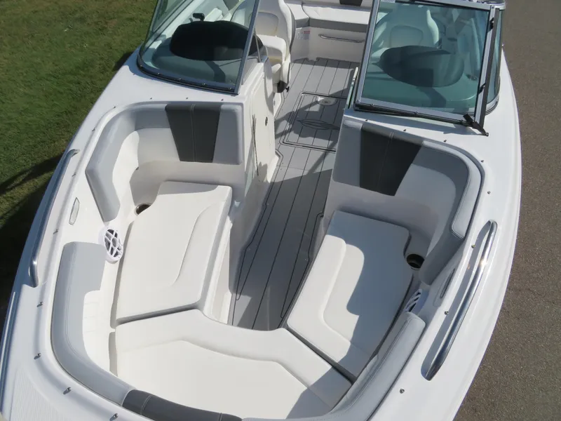Slide: The Image of 2025 Chaparral 23 SSi boat interior with white seating and open deck layout. - 12