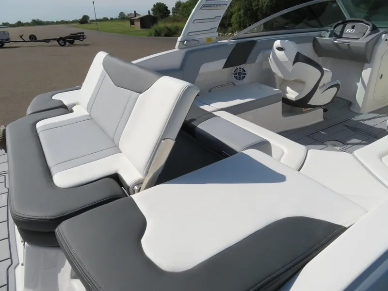 Slide: The Image of 2025 Chaparral 23 SSi boat interior with sleek white and gray seating. - 6