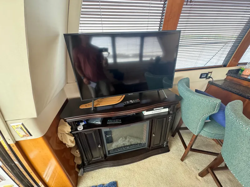 Slide: The Image of Interior of 2000 Carver 530 Voyager Pilothouse with TV and fireplace cabinet. - 13