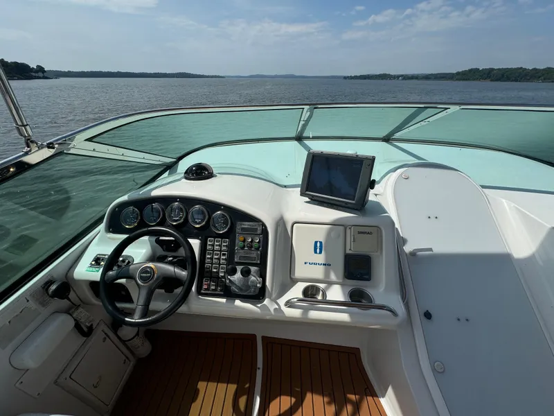 Slide: The Image of Pilothouse of 2000 Carver 530 Voyager yacht with steering wheel and navigation controls. - 19