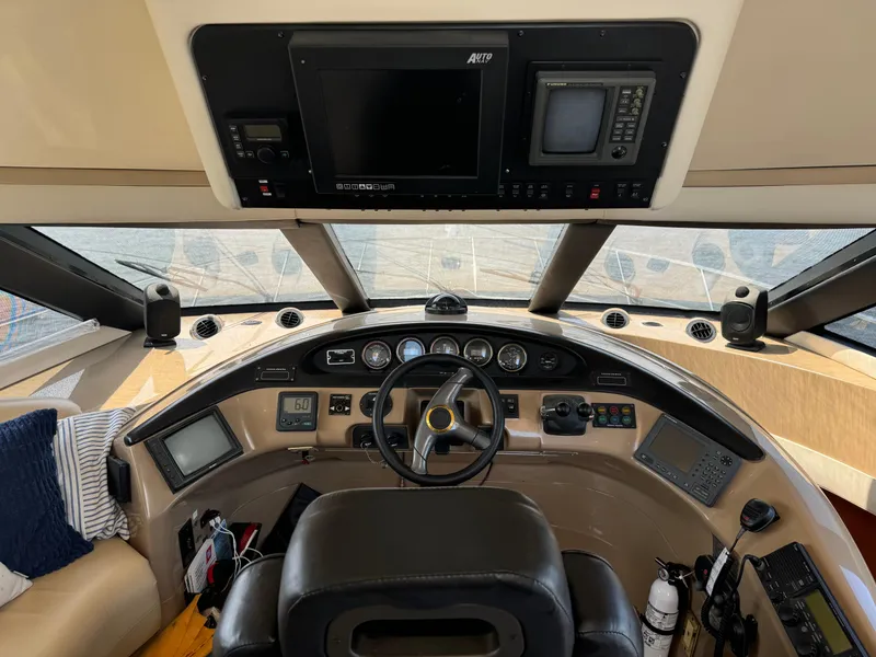 Slide: The Image of Pilothouse interior of 2000 Carver 530 Voyager, featuring navigation equipment and steering wheel. - 23