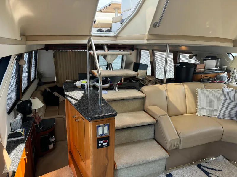 Slide: The Image of Interior of 2000 Carver 530 Voyager Pilothouse with beige seating and modern design. - 26