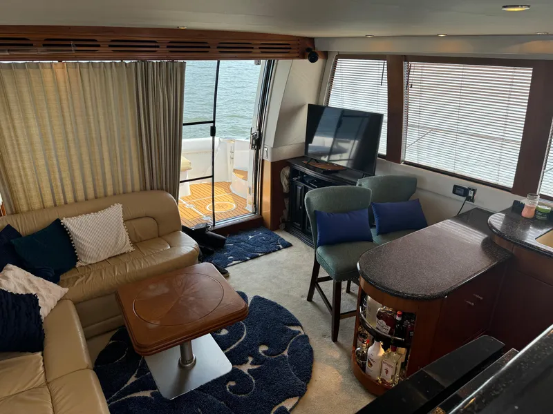 Slide: The Image of Luxurious interior of 2000 Carver 530 Voyager Pilothouse with seating, TV, and bar area. - 27