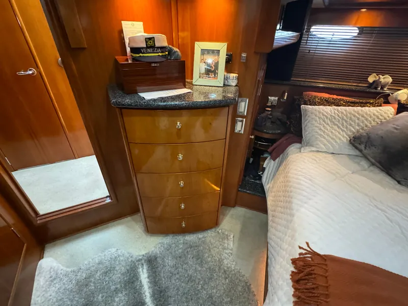 Slide: The Image of Luxurious bedroom interior of 2000 Carver 530 Voyager Pilothouse yacht with elegant wood cabinetry. - 31