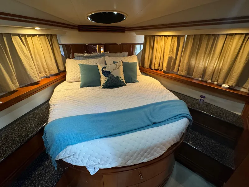 Slide: The Image of Luxurious bedroom in 2000 Carver 530 Voyager Pilothouse yacht with cozy bedding and elegant decor. - 38