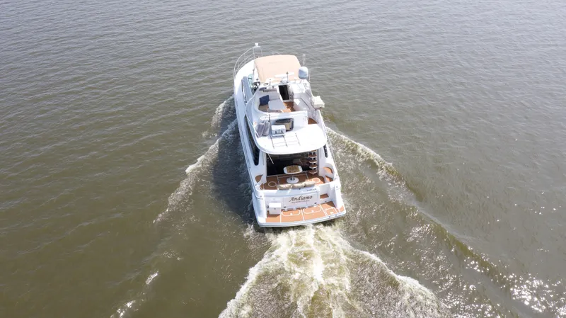 Slide: The Image of 2000 Carver 530 Voyager Pilothouse cruising on open water, aerial view. - 4
