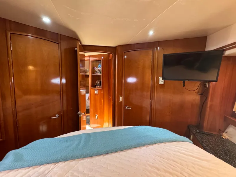 Slide: The Image of Luxurious cabin interior of 2000 Carver 530 Voyager Pilothouse with wood paneling and TV. - 40