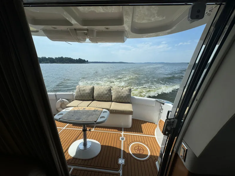 Slide: The Image of 2000 Carver 530 Voyager Pilothouse yacht with elegant deck seating and scenic water view. - 41