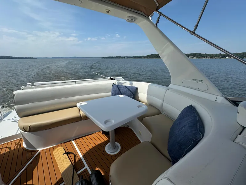 Slide: The Image of 2000 Carver 530 Voyager Pilothouse yacht with outdoor seating and table on calm water. - 42