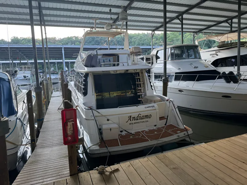 Slide: The Image of 2000 Carver 530 Voyager Pilothouse docked in a covered marina. - 45