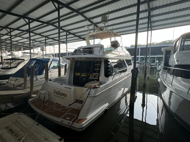 Slide: The Image of 2000 Carver 530 Voyager Pilothouse yacht docked in a covered marina. - 46