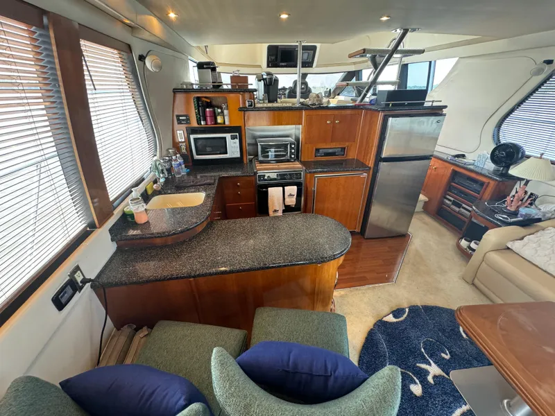 Slide: The Image of Interior of 2000 Carver 530 Voyager Pilothouse with modern kitchen and seating area. - 8