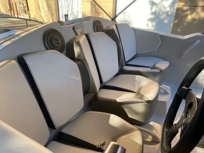 Slide: The Image of 2015 Scarab 165 Standard boat interior with three seats and steering wheel. - 11