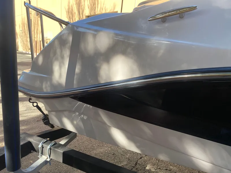 Slide: The Image of 2015 Scarab 165 Standard boat on trailer, side view in sunlight. - 13