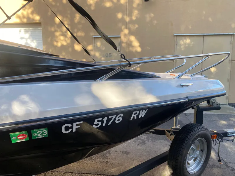 Slide: The Image of 2015 Scarab 165 Standard boat on trailer, side view with registration number visible. - 14