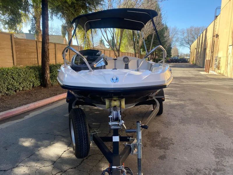 Slide: The Image of 2015 Scarab 165 Standard boat on trailer, parked outdoors. - 17
