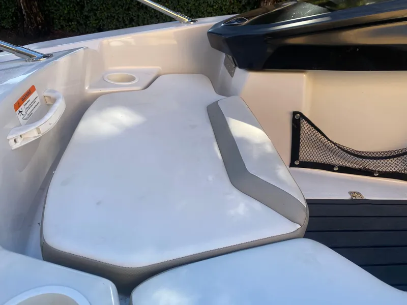 Slide: The Image of 2015 Scarab 165 Standard boat interior with white seating and storage net. - 19