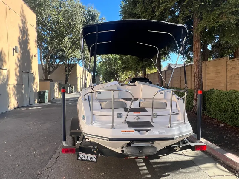 Slide: The Image of 2015 Scarab 165 Standard boat on trailer, parked in a sunny alleyway. - 24