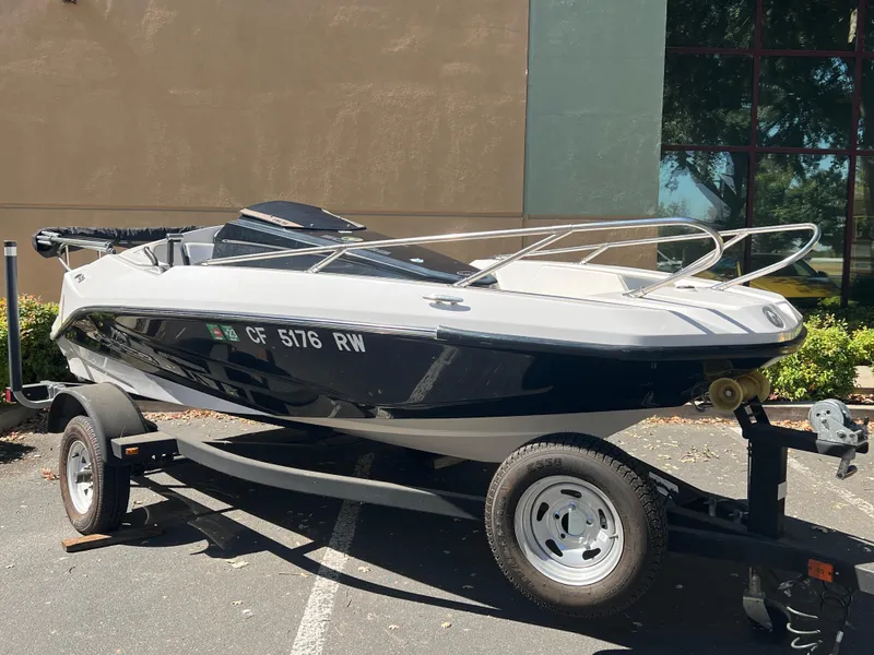 Slide: The Image of 2015 Scarab 165 Standard boat on trailer, parked outdoors. - 26