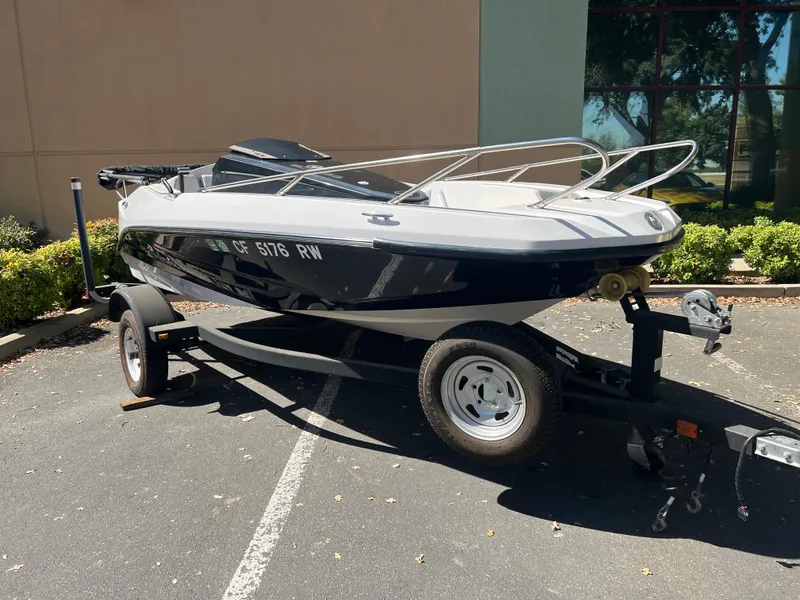 Slide: The Image of 2015 Scarab 165 Standard boat on trailer in parking lot. - 27