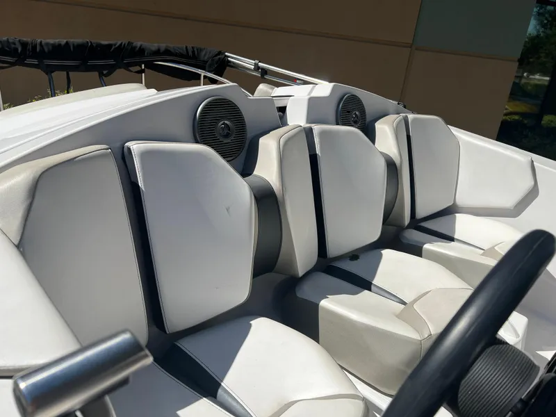Slide: The Image of 2015 Scarab 165 Standard boat interior with white seating and speakers. - 29