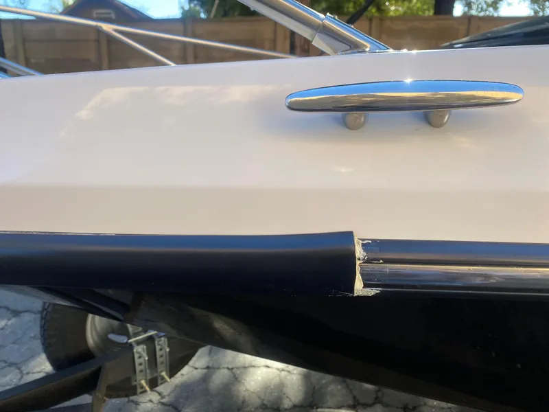 Slide: The Image of 2015 Scarab 165 Standard boat detail showing cleat and rail damage. - 3