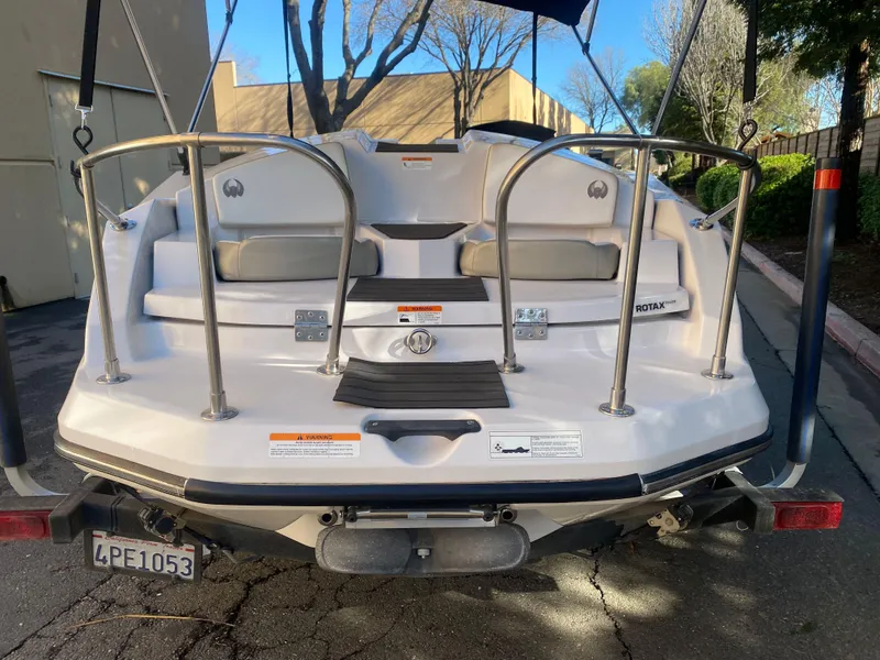 Slide: The Image of 2015 Scarab 165 Standard boat rear view with seating and safety railings. - 6