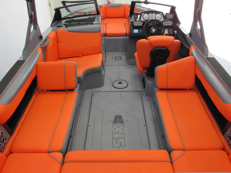 Slide: The Image of 2021 Axis T23 boat interior with vibrant orange seating and modern dashboard. - 12