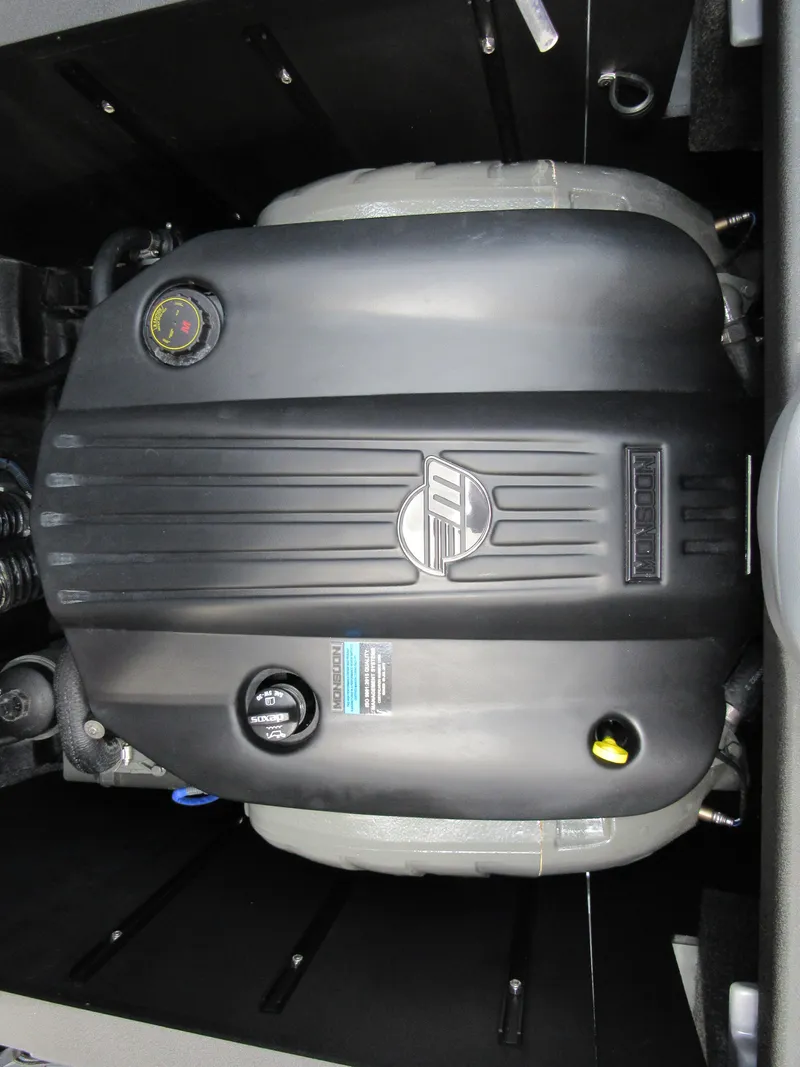 Slide: The Image of 2021 Axis T23 engine compartment with black cover and visible components. - 13