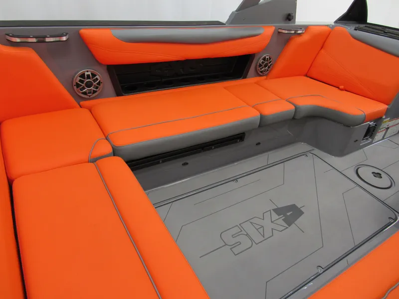 Slide: The Image of 2021 Axis T23 boat interior with orange and gray seating, featuring built-in speakers. - 6