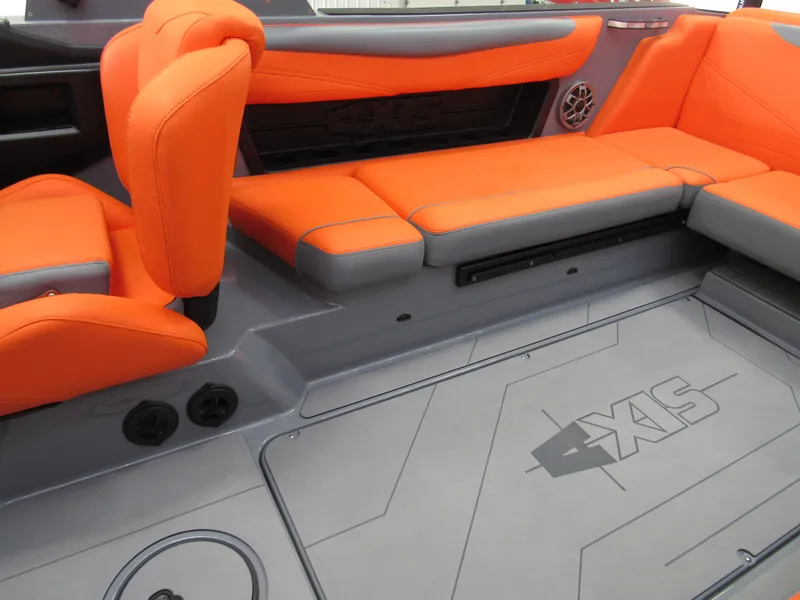 Slide: The Image of 2021 Axis T23 boat interior with orange seating and gray flooring. - 7