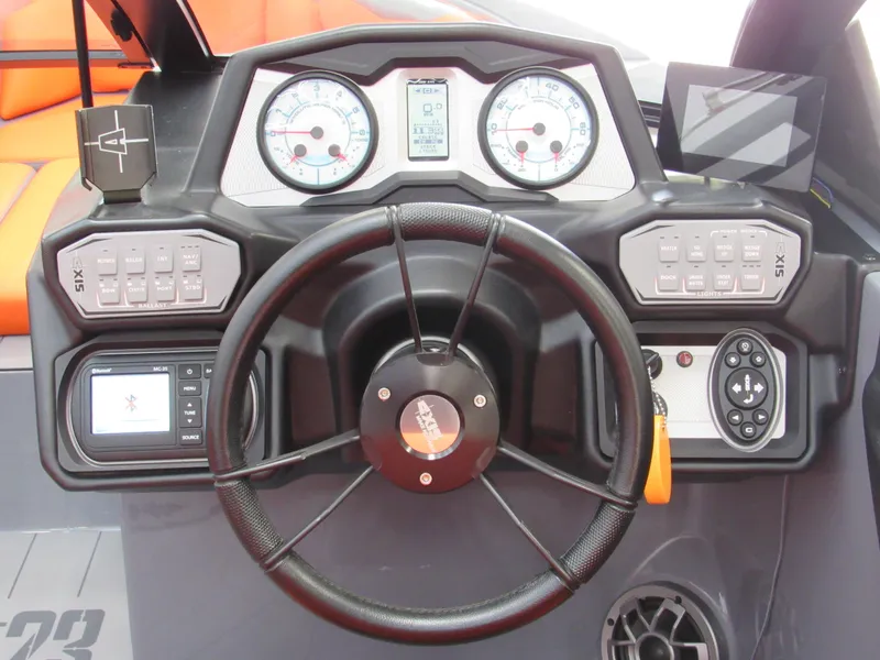 Slide: The Image of 2021 Axis T23 boat dashboard with steering wheel, gauges, and control panels. - 8