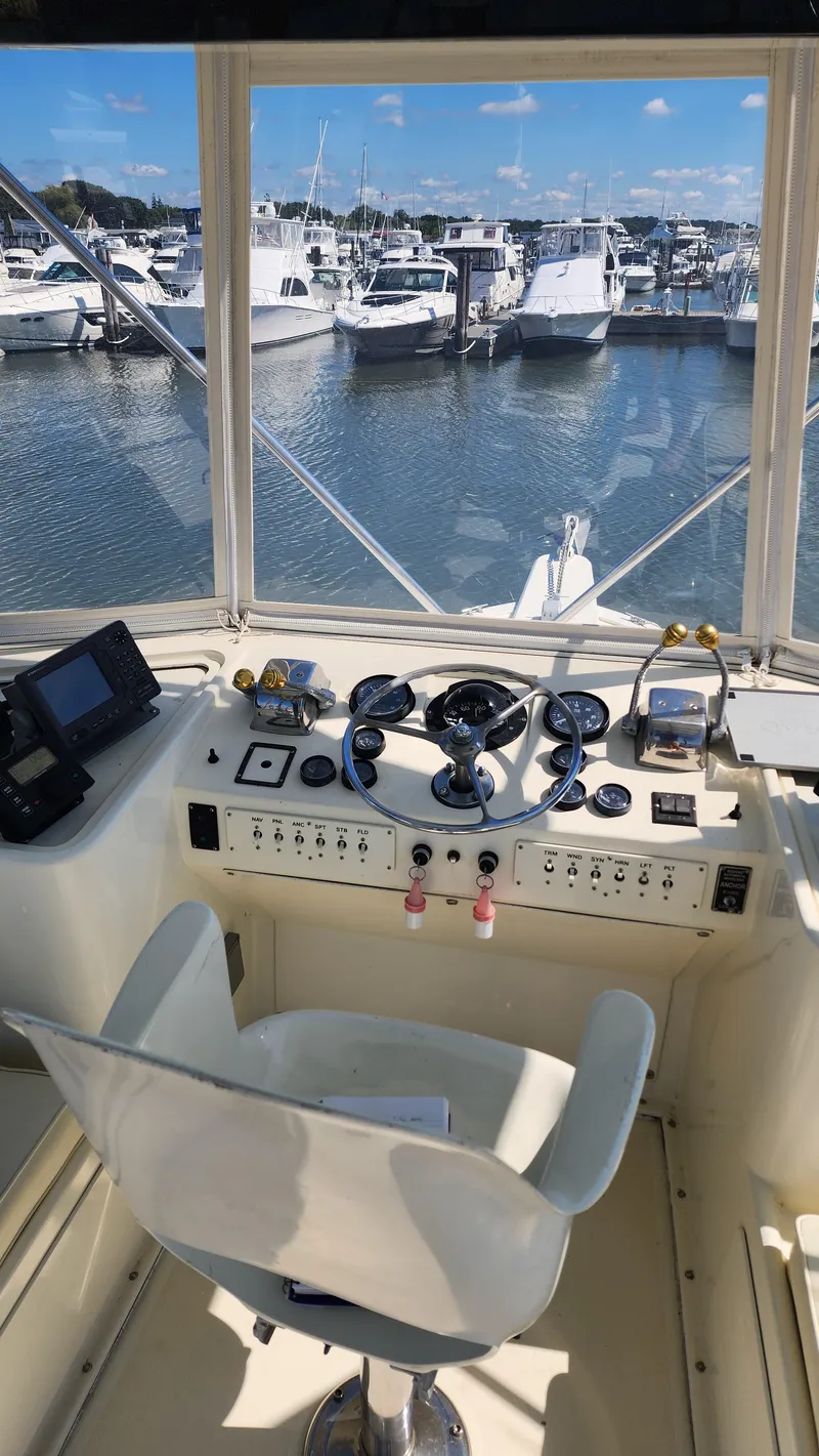 Slide: The Image of Helm of 1969 Hatteras 36 Sport Fisherman overlooking marina. - 18