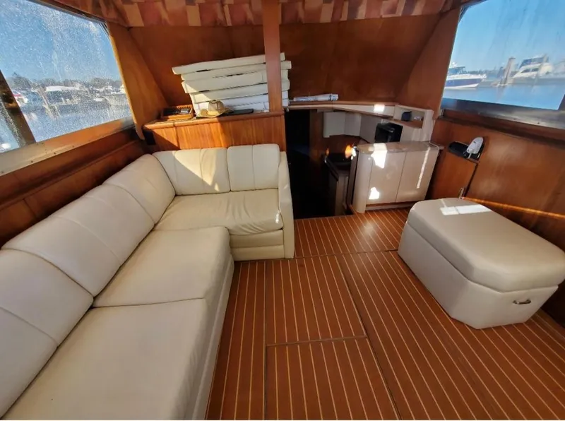 Slide: The Image of Interior of 1969 Hatteras 36 Sport Fisherman with beige seating and wooden flooring. - 21